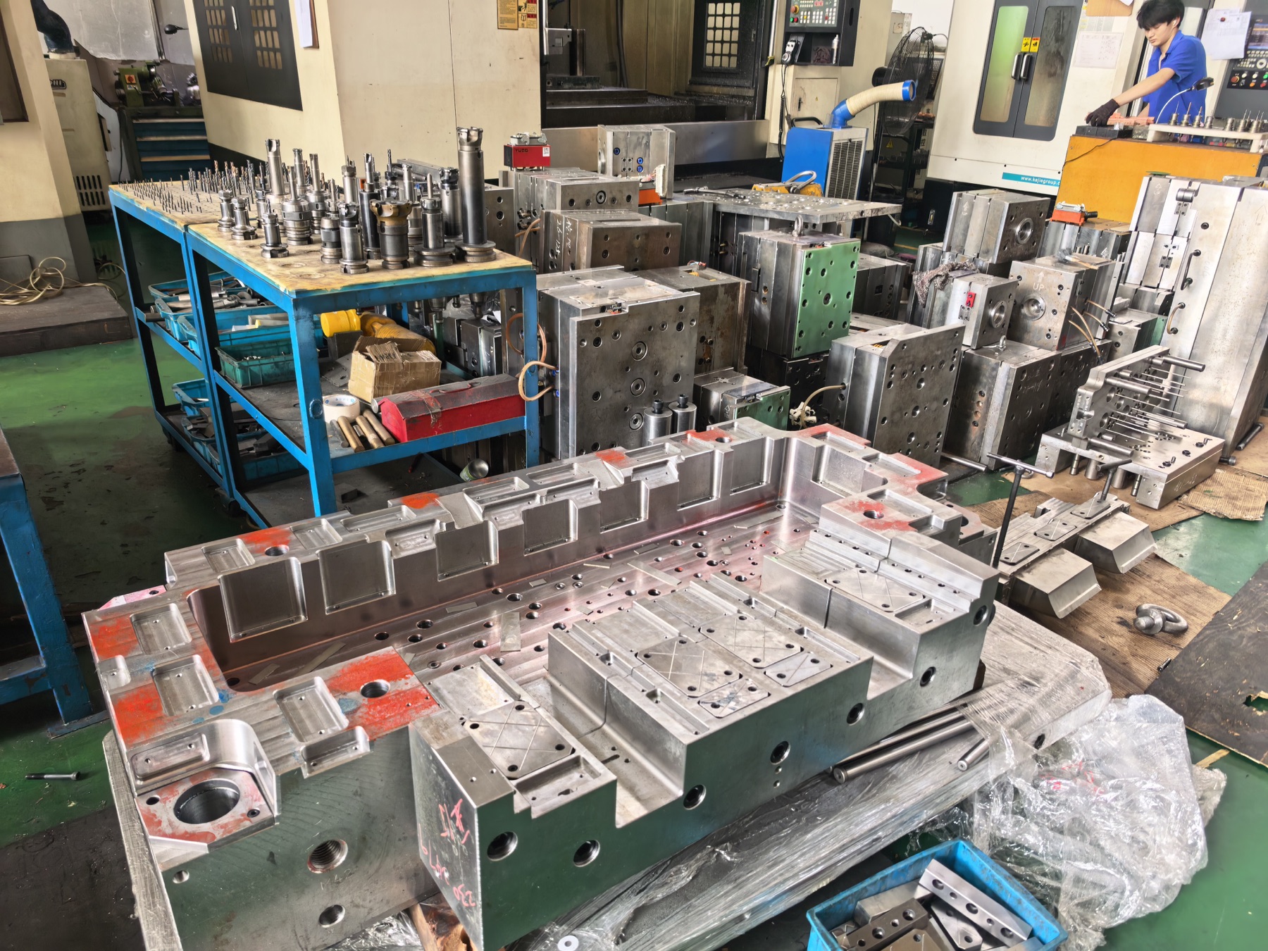 Steel injection molds and tooling arranged in the mold workshop